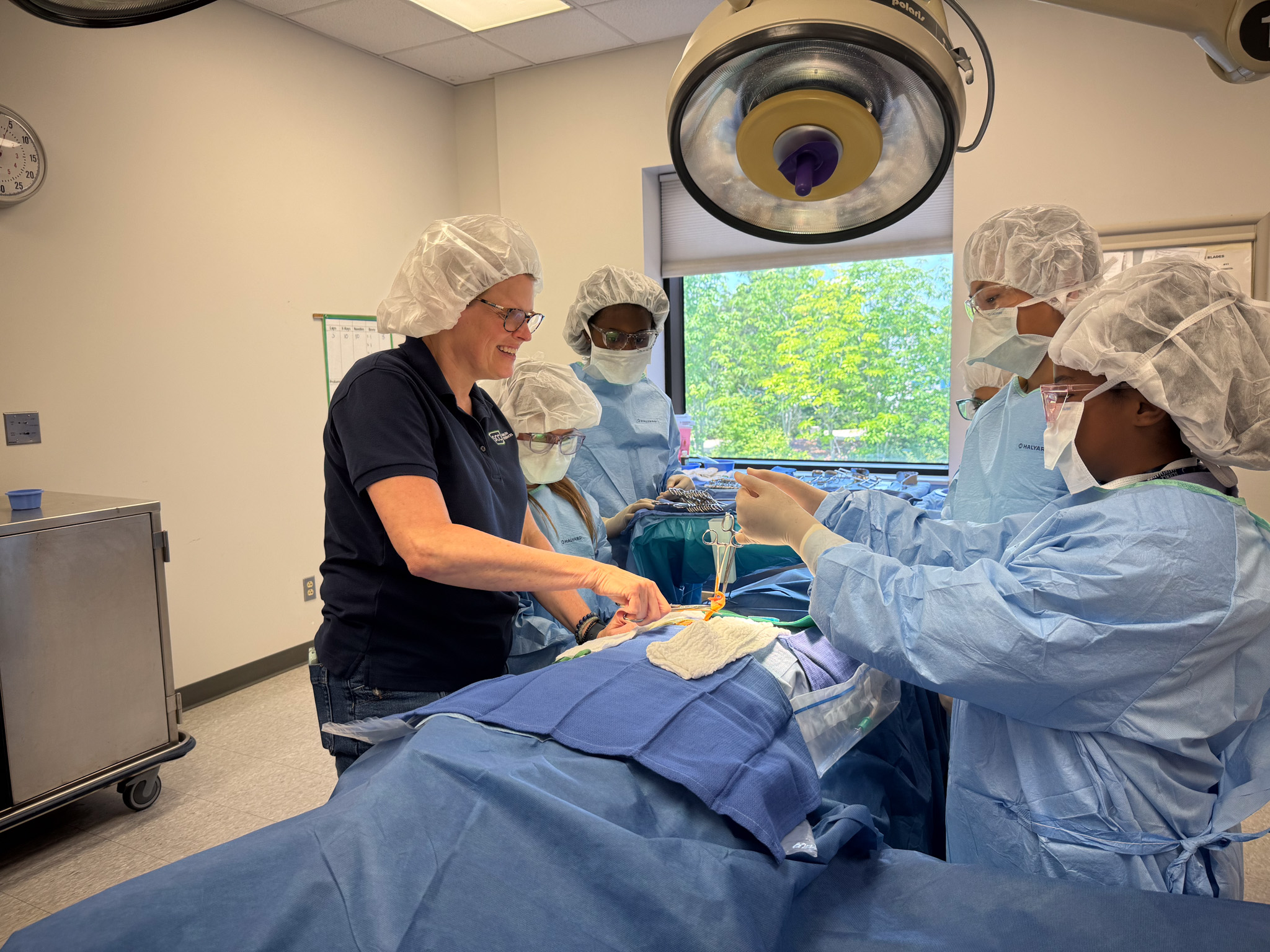 Photo of doctors performing a medical procedure on a patient in an operating room