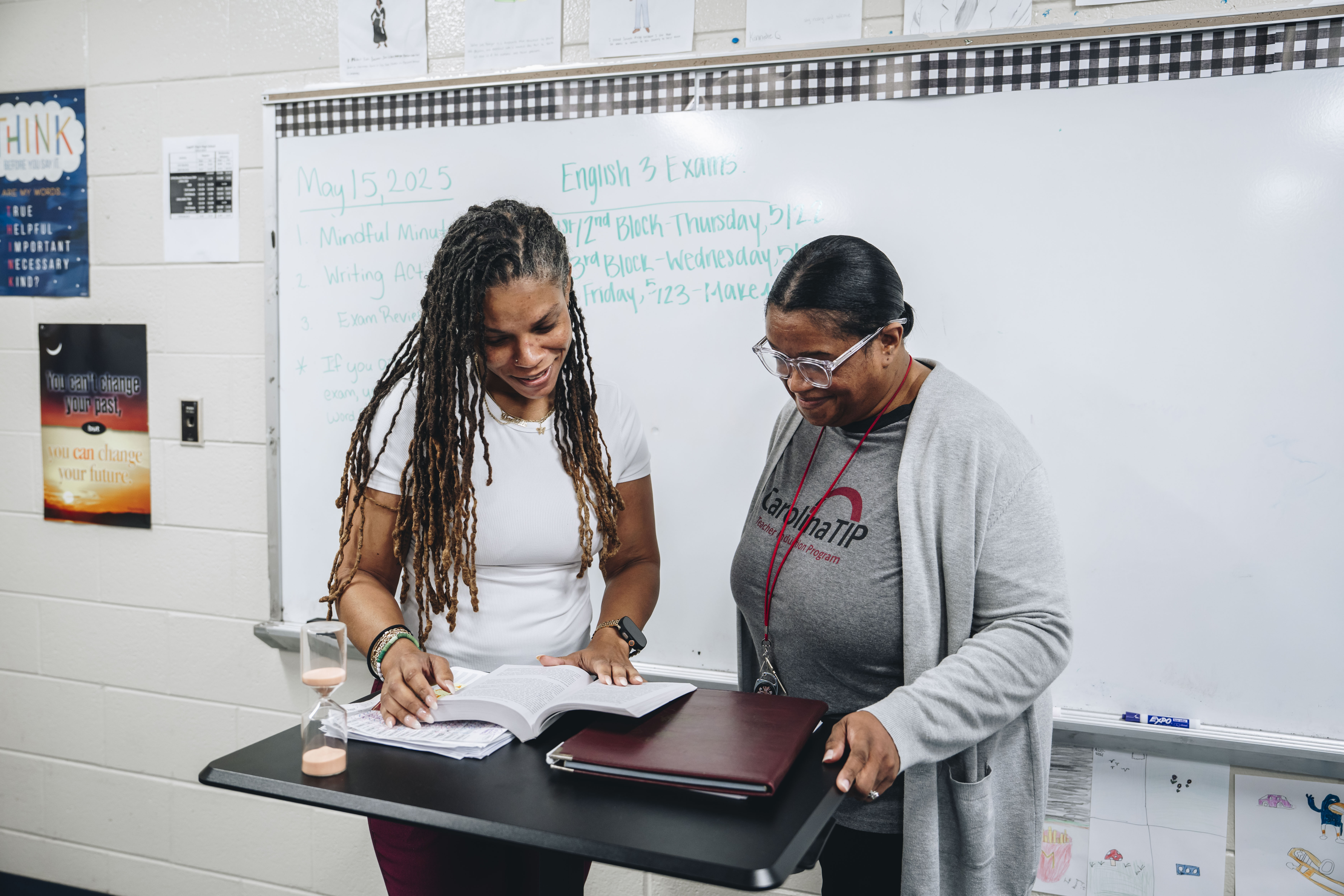 Photo of two women collaborating in a classroom, one wearing a Carolina TIP shirt
