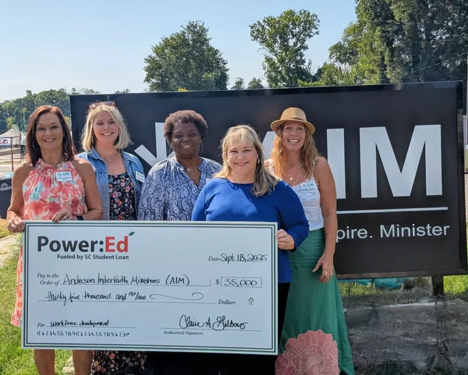 Women pose with ceremonial big check
