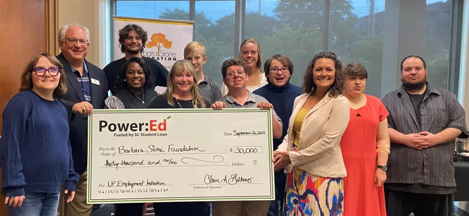 People pose with ceremonial big check