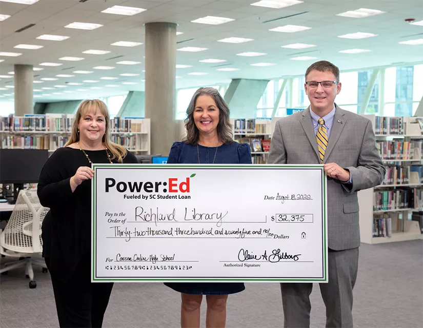 Richland Library and SC Student Loan executives pose with ceremonial check