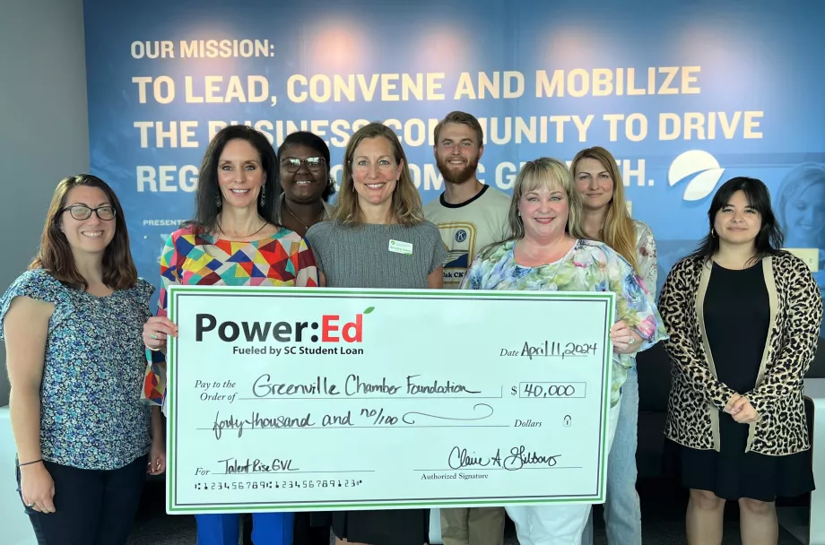 People pose with ceremonial big check