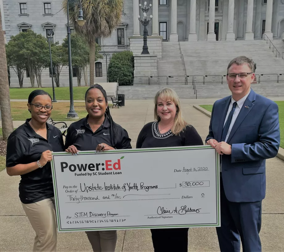 UIYP and SC Student Loan executives pose with ceremonial check