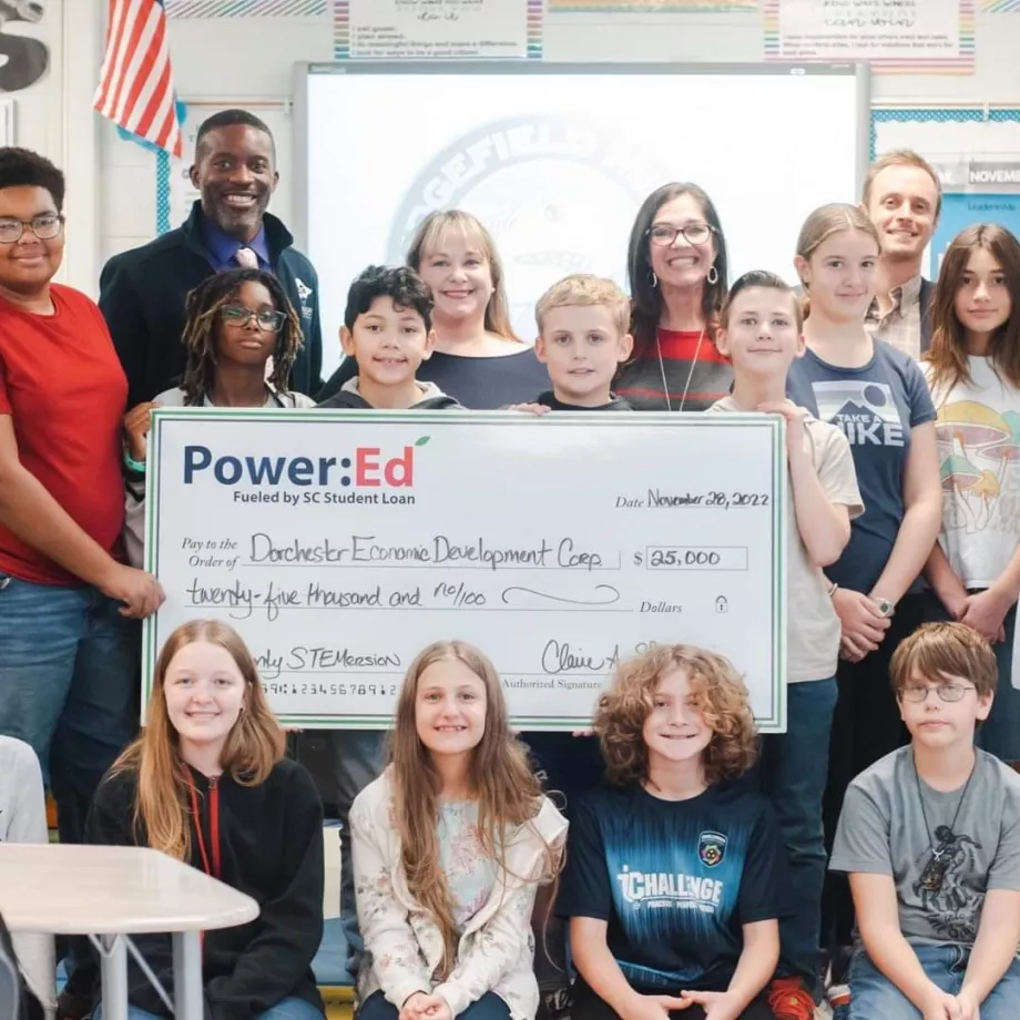 People pose with ceremonial check