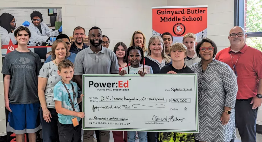 People pose with ceremonial check