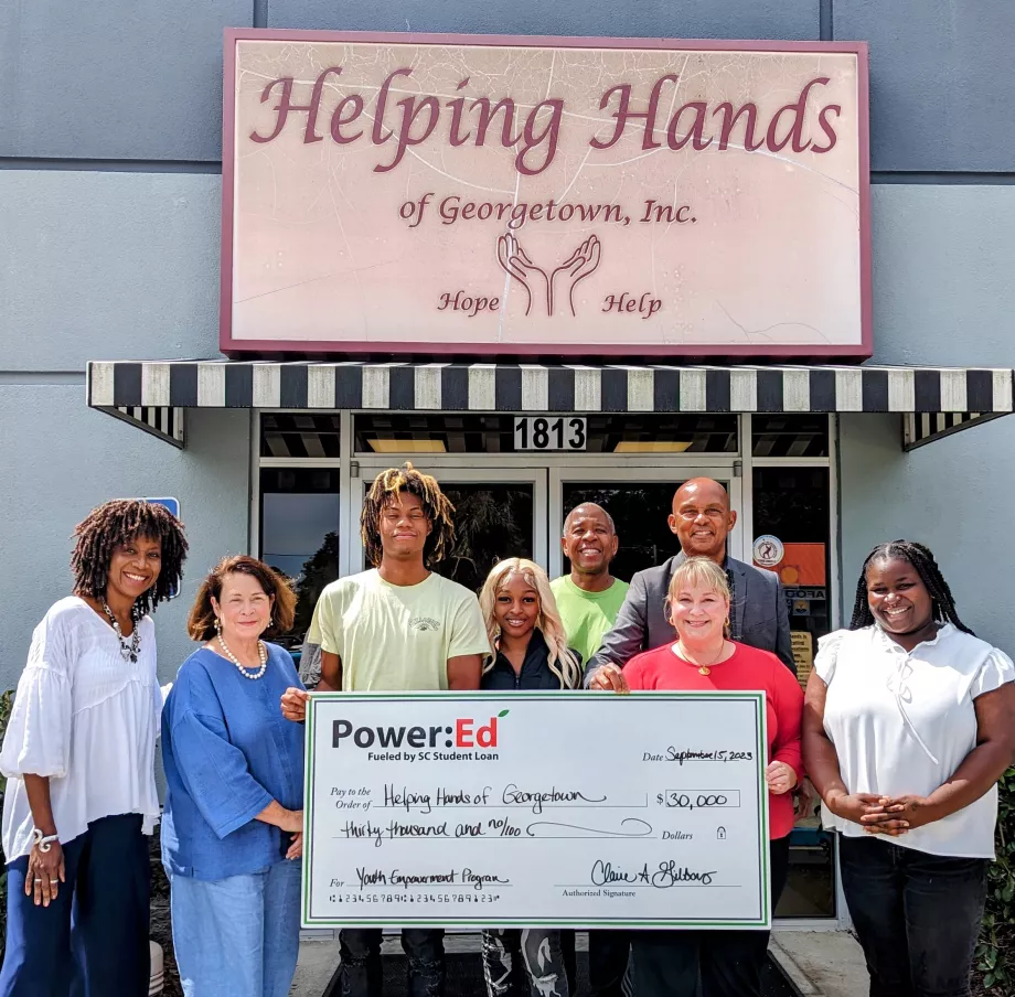 People pose with ceremonial big check