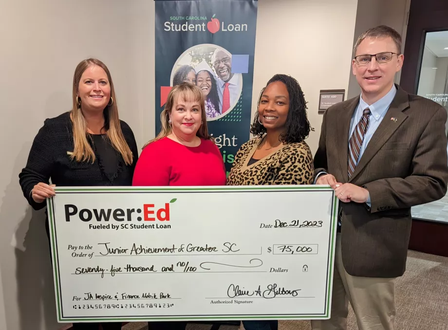 People pose with ceremonial big check