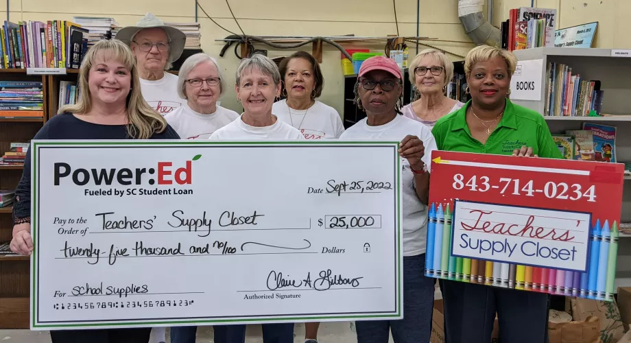 People pose with ceremonial check