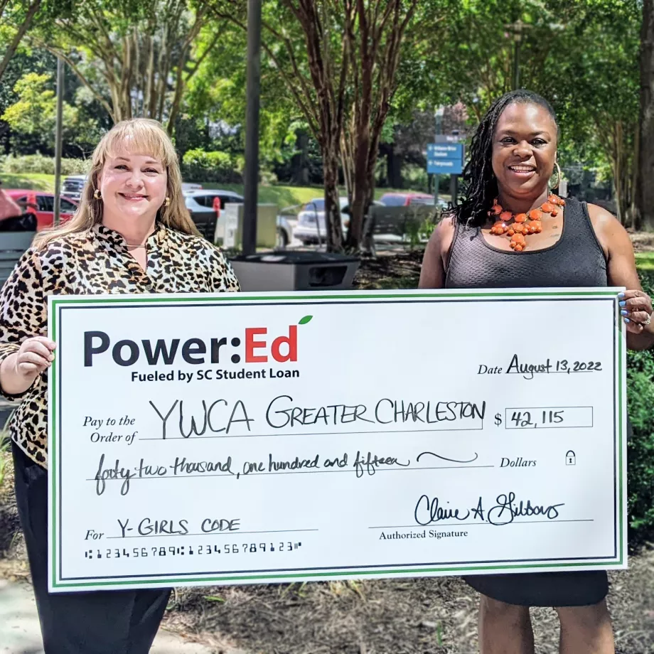 Executives pose with ceremonial check