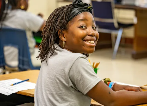 Photo of smiling girl at desk